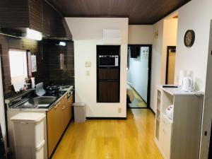 a kitchen with a sink and a stove at Maisonity Suizenji - Vacation STAY 10562v in Kumamoto