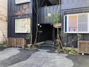 a black house with a door and windows at Maisonity Suizenji - Vacation STAY 10562v in Kumamoto