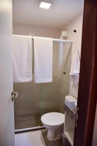 uma casa de banho com chuveiro, WC e toalhas em CASA SERRAMBI - 7QTS + PISCINA PRIVATIVA BY SEU FLAT em Porto de Galinhas