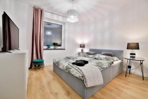 Posteľ alebo postele v izbe v ubytovaní Nowoczesne Apartamenty typu Superior - Bulwary Rabka Zdrój - Balia - Blisko Park Zdrojowy