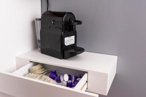 a black mixer sitting on top of a white drawer at Jolie maison proche centre-ville et plages in Granville