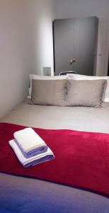 a bed with a red and white blanket on it at Alegramente in Lisbon