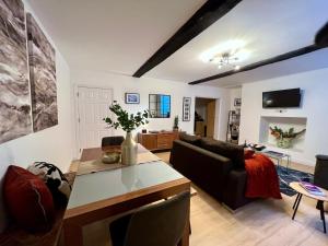 a living room with a couch and a table at Superbly located 2 bedroom luxury apartment in Bath