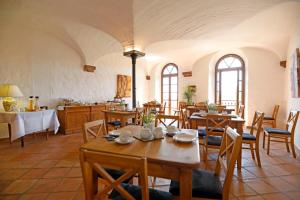 a dining room with wooden tables and chairs at Landhotel Hofgut Battenberg in Battenberg
