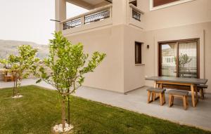 a patio with a table and bench in a house at Thyme Sea View Apartments in Souda