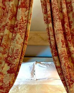 a bedroom with a bed with a curtain at Villa la Moresca Relais de Charme BeB Adults only in Montecatini Terme