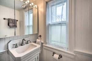 a bathroom with a sink and a mirror and a window at Spacious Getaway 7 Mi to Whitetail Slopes! in Mercersburg +21 photos
