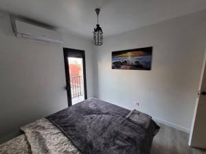 A bed or beds in a room at Apartamentos SABINILLAS