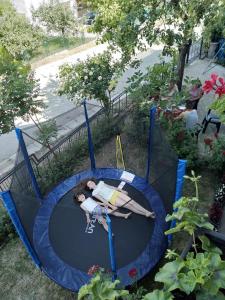 a woman is laying on a trampoline at Sanja Accomodation in Soko Banja