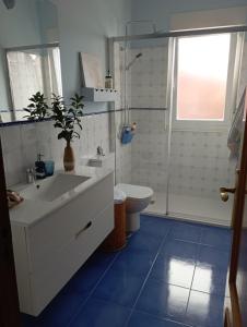 a bathroom with a sink and a toilet and a shower at Casa Pepa in Cambados