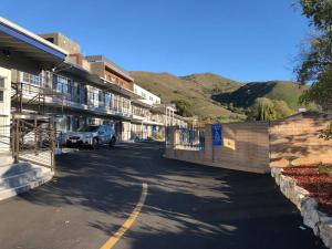 a car parked in a parking lot next to a building at University Inn at San Luis Obispo in San Luis Obispo