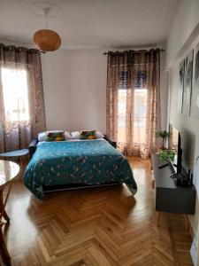 1 dormitorio con 1 cama, 1 mesa y 2 ventanas en Casa di Raffi Sanremo en San Remo