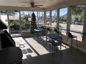 un restaurant avec des tables et des chaises et un sapin de Noël dans l'établissement University Inn at San Luis Obispo, à San Luis Obispo