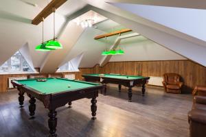 a room with two pool tables in a attic at Serebryaniy Vek in Tarusa