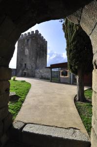 a view of a castle through a stone wall at O Visconde - Alojamento local in Lamego +11 photos