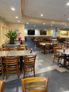 a restaurant with tables and chairs and a cafeteria at Ramada Plaza by Wyndham Waikiki in Honolulu