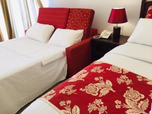 a hotel room with two beds and a telephone at Bayfront in Weligama