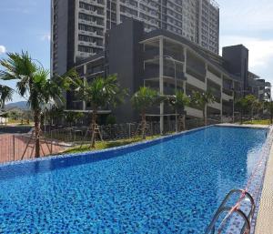 a large swimming pool in front of a building at Imanz Homestay 3 Bedroom & 3 Bathroom in Kajang