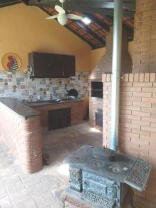 a kitchen with an outdoor stove in a room at Casa com piscina - itupeva in Itupeva