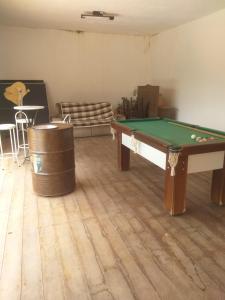 a room with a pool table and a barrel at Casa com piscina - itupeva in Itupeva