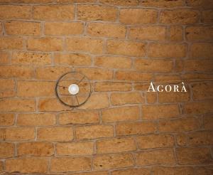 a brick wall with a fan on it at Agorà Home in Terrasini