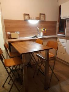 cocina con mesa con sillas y fregadero en Studio 4 couchages, en Auron