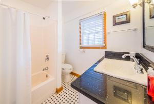 a bathroom with a sink and a toilet at A Summer Place in Duck +38 photos