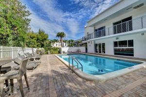 a swimming pool in the backyard of a house at 365 Ocean in Boca Raton