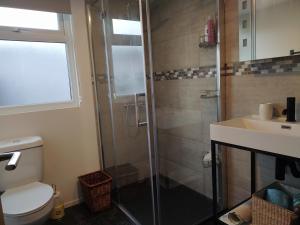 a bathroom with a shower and a toilet and a sink at Offa Home in Leamington Spa