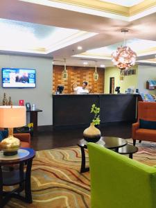 a lobby of a hotel with a reception desk at Best Western Plus Universal Inn in Orlando