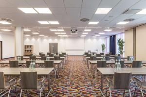 une salle de conférence avec des tables et des chaises et un tableau blanc dans l'établissement Park Inn by Radisson Neumarkt, à Neumarkt in der Oberpfalz