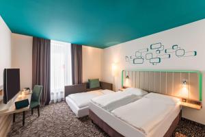 Postel nebo postele na pokoji v ubytování Park Inn by Radisson Neumarkt