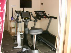 a room with a gym with a treadmill and a phone at Alpine Lodge 6 in Les Contamines-Montjoie