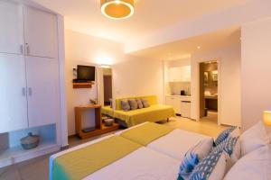 a bedroom with a bed and a living room at Iris Skiathos in Skiathos