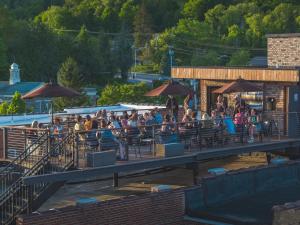 a group of people sitting at a bar with umbrellas at The Horton Hotel in Boone