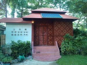 a smallshed with a bench in front of it at Banpainamhomestay in Ban Huai Thalaeng Phan