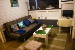 a living room with a couch and a table at Les Bougainvilliers Tropicaux in Sans Pareil