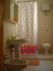 a bathroom with a shower curtain and a sink at B&B Antonella in Introdacqua