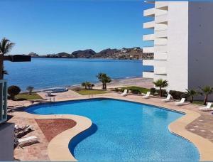 a swimming pool with a view of the water at Condominio Posada 314 San Carlos in San Carlos