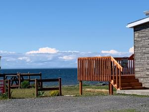 a group of benches sitting next to the ocean at Les studios de la mer in Matane