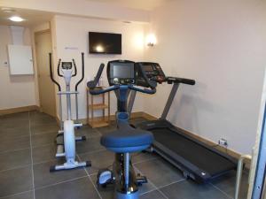 a room with a gym with a treadmill and a tv at Alpine Lodge 3 in Les Contamines-Montjoie