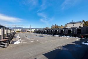 an empty parking lot with a bunch of containers at HOTEL R9 The Yard Inabe in Kuwana