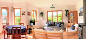 a living room with a couch and a table at Ferienwohnung Am Wundergraben inkl. Chiemgaukarte in Ruhpolding