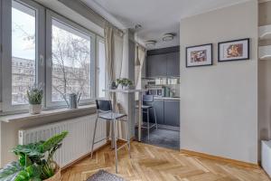 a kitchen with a large window and a table at Plater Residence Apartments in Warsaw