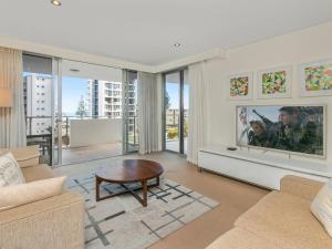una sala de estar con un sofá y una mesa en Eden Apartments Unit 401, en Gold Coast