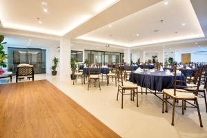 a banquet hall with tables and chairs in a building at Commander Suites de Boracay in Boracay