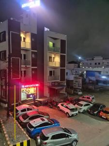 a group of cars parked in a parking lot at night at Arihanth Inn in Vellore