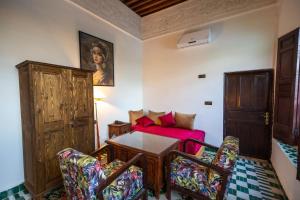 a living room with a table and a couch at Riad Soultana in Fès