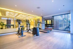 a gym with treadmills and ellipticals in a building at Commander Suites de Boracay in Boracay