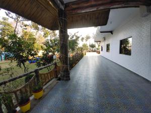 a hallway with a tile floor and a fence at The Buddha Resort in Gaya